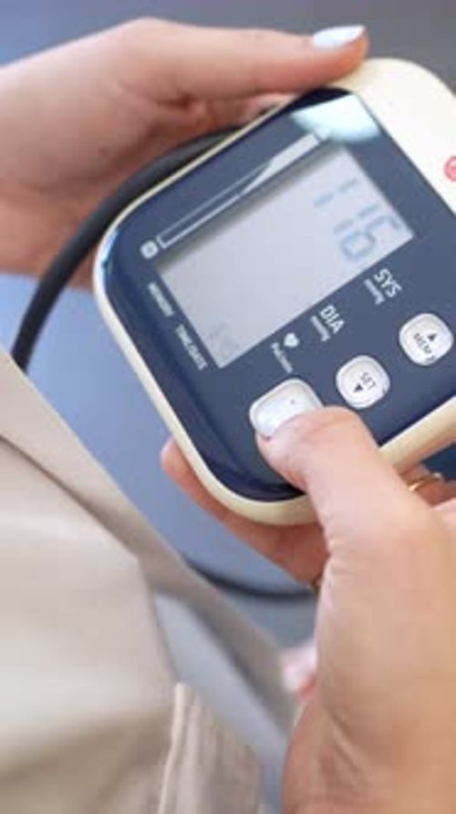 Female Pharmacist Measuring Patient's Blood Pressure