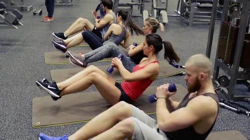 Young People in Crossfit Gym Working Their Abs Abdominal