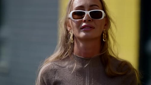 Beautiful Woman with Sunglasses is Walking Alone in City in Summer Day Portrait Outdoors