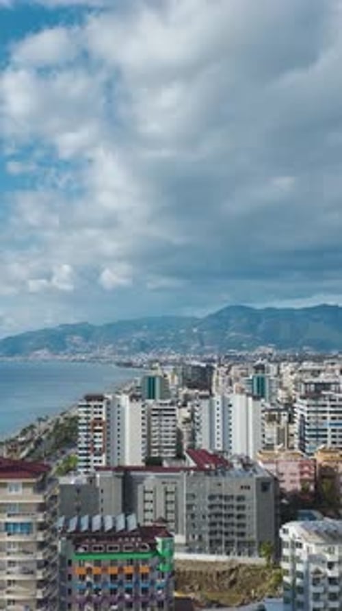Vertical Video Coastal City Buildings Overlooking the Ocean and Blue Sky Creating a Stunning