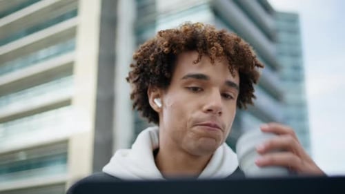 Earbuds Hipster Sipping Coffee at Urban Place Closeup Student Learning Laptop