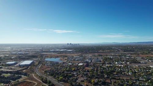 Drone aerial view flying to the left of downtown Denver skyline