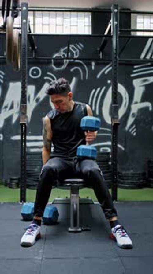 Man Lifting Weights on Bench Press in Gym