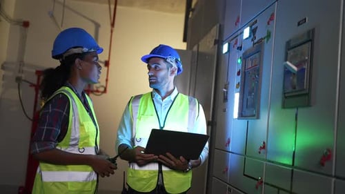 Engineers are checking electronic system at basement.