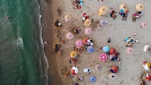 colorful umbrellas on the beach and drone view of the sea