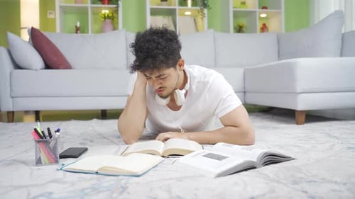Confused male student studying.