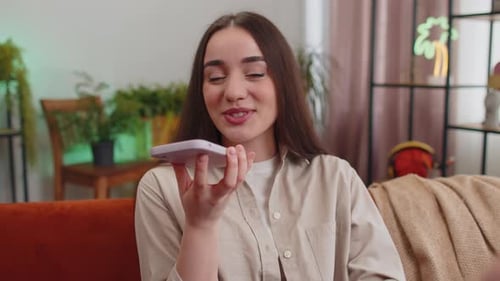 Young Woman Using Voice Command on Smartphone