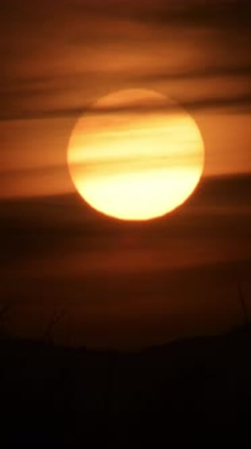 Golden Sun Sets Behind Dark Ridges