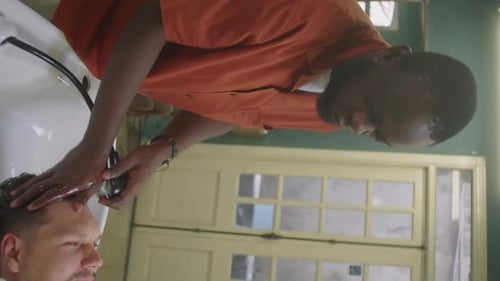 Barber Washing Hair of Male Client by Hairdressing Basin