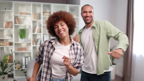 Young Couple Dancing and Singing at Home