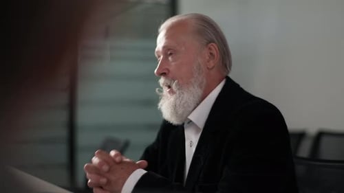 Closeup Portrait of Serious Mature Adult Male Mentor Leader Talking to Colleagues Executive Team