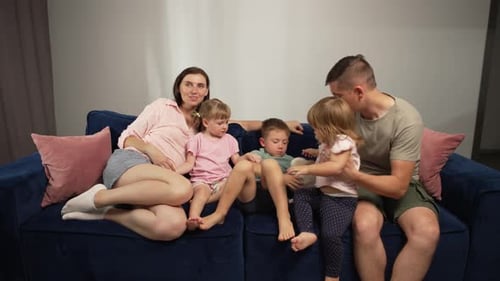 Family Cuddles with Dog on the Couch
