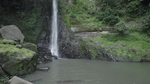 Waterfall Cascading Into Pool in Lush Nature