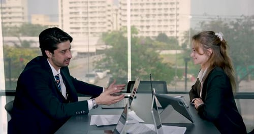 Business Meeting Between Man and Woman in Office