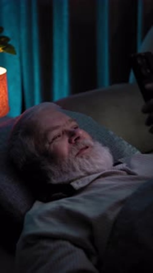 At Night an Elderly Man Lay in Bed and Talking to Someone Via Video Call