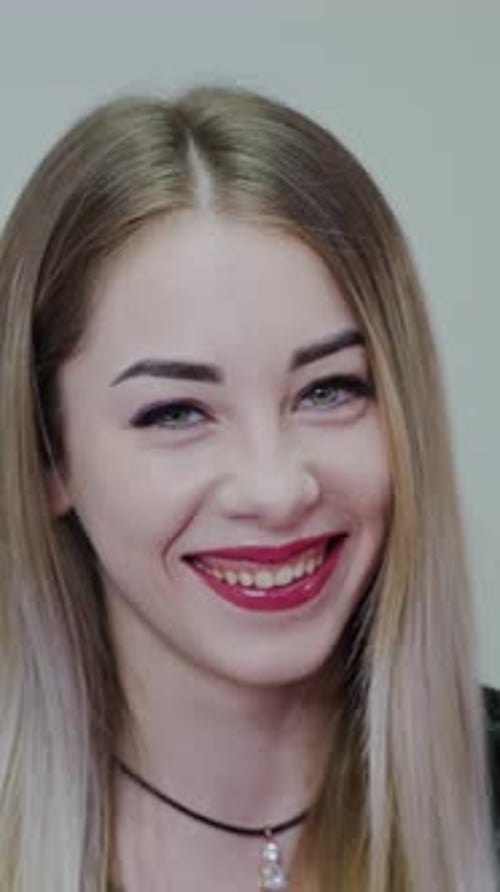 Beauty Woman Face Portrait. Happy beautiful woman face close up in studio. Vertical video