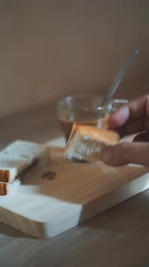 Dipping a Sandwich into Hot Caffeinated Beverage