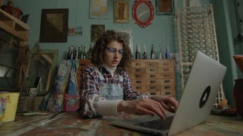 Woman Working Online In Creative Workshop