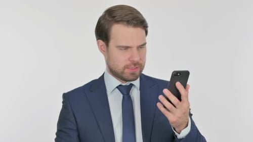 Frustrated Businessman Using Mobile Phone