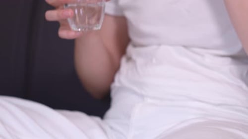 Taking Pill With Water Close Up Indoors