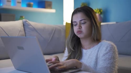 Woman Talking on Laptop at Home at Night