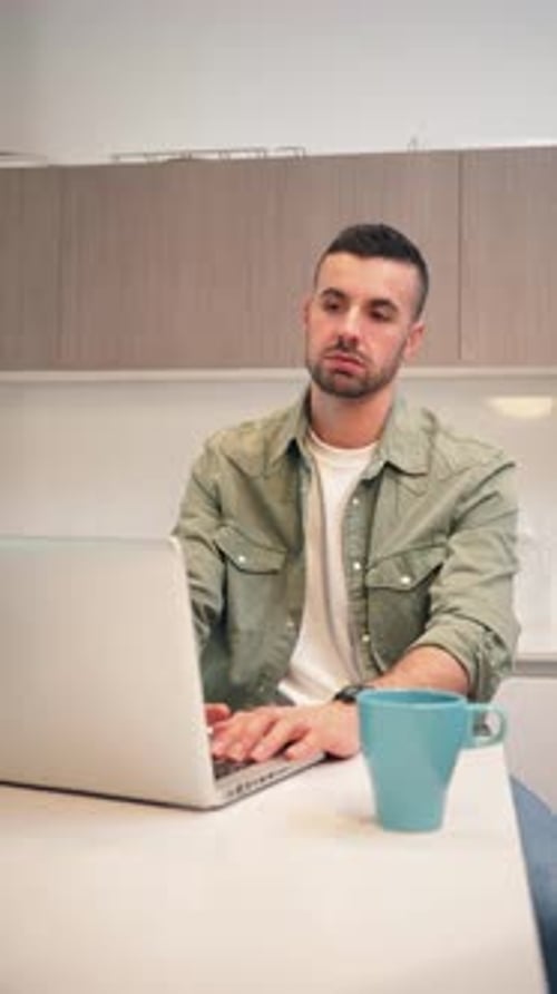 Stressed Young Adult Closing Laptop at Home