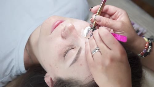 Eyelash Extension Application on Reclining Woman