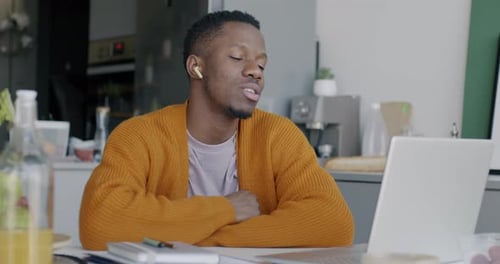 African American Man Making Online Video Call with Laptop and Wireless Earphones Talking During