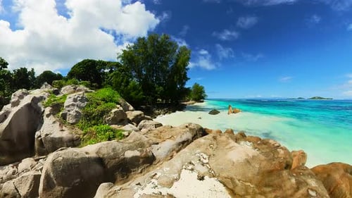 Rocky Shoreline with Azure Water and Blue Sky