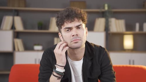 Pensive Young Adult Thinking on Couch