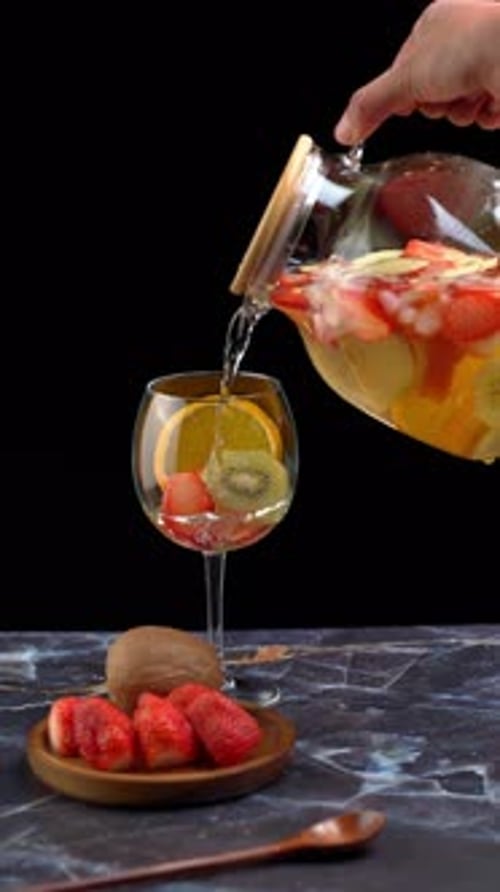 Vertical Video, Serving White Clericot In A Wine Glass With Decorative Fruits