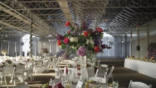 Flower bouquet arrangement on a wedding banquet dining table in venue hall