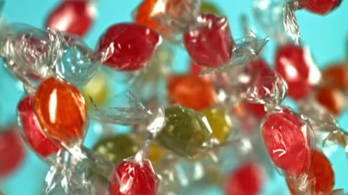 Colorful Wrapped Candy Floating on a Blue Background