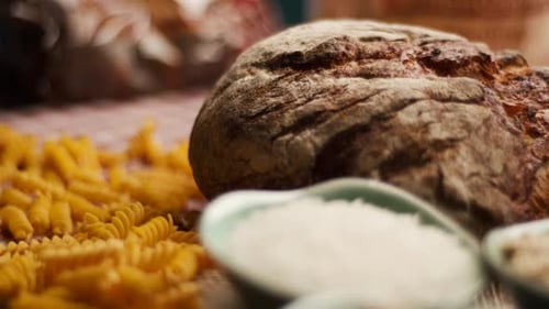Wholegrain Bread And Pasta on Table CloseUp