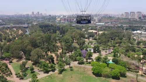 Aerial Shot Of Hot Air Balloon Descending Over Yarkon Park Against Sky In City