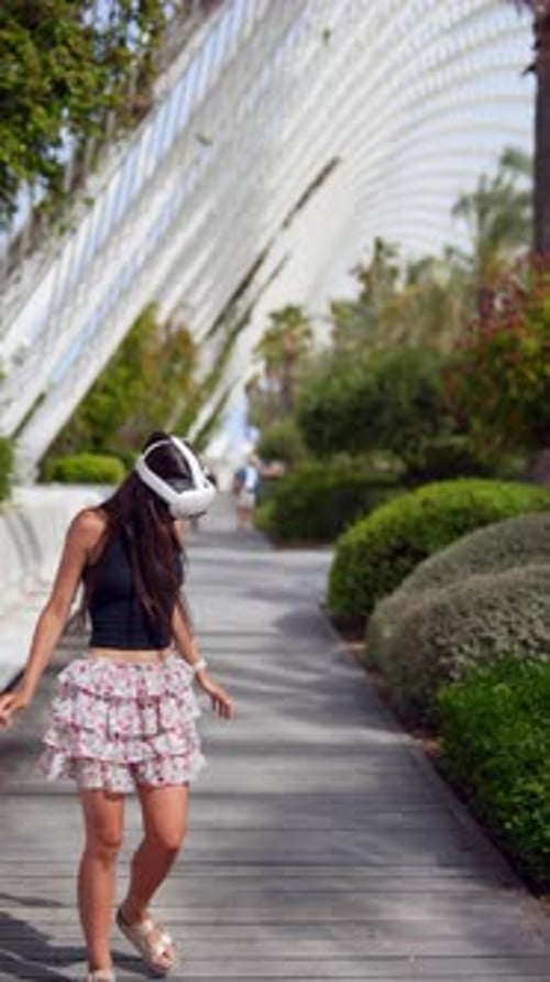 A Woman is Experiencing Virtual Reality While Being in an Urban Park Environment