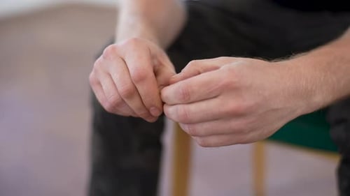 Closeup Hands of Unrecognizable Nervous Young Man Sharing Traumatic Experience at Therapy Meeting