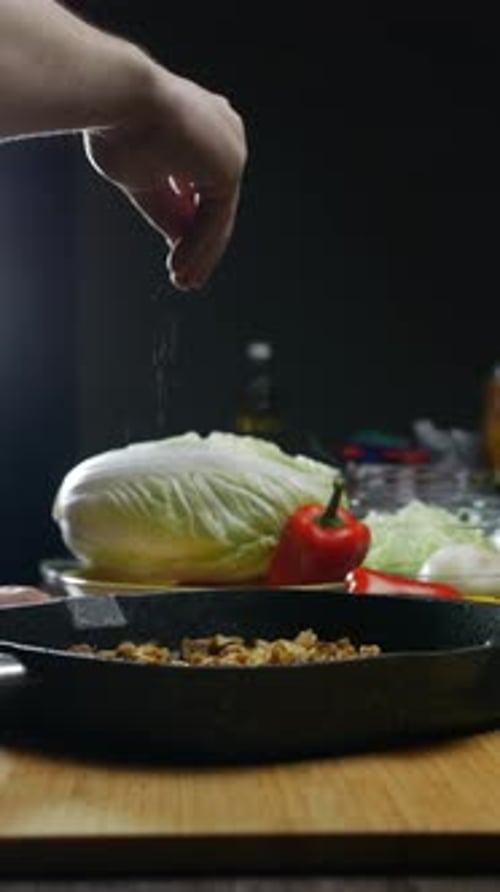 Man Seasoning Readymade Poultry in the Restaurant's Kitchen