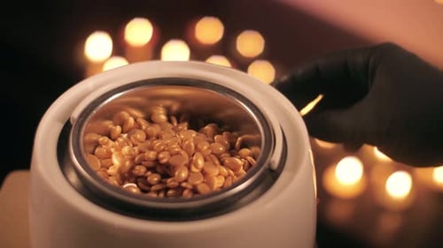 Preparation of Gold Wax Wax for Depilation is Heated and Melted in a Container