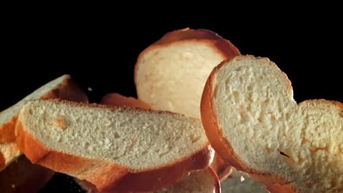Trozos de pan en rodajas vuelan y caen filmados con una cámara de alta velocidad a 1000 fps