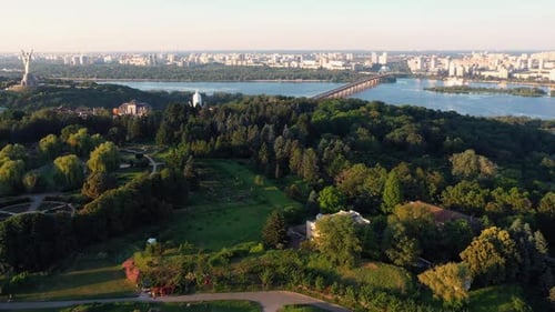 Aerial View of Summer Cityscape with Residential Buildings Green Park and Beautiful River