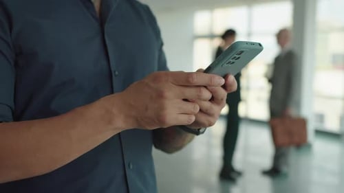 Entrepreneur Checking Messages on Smartphone