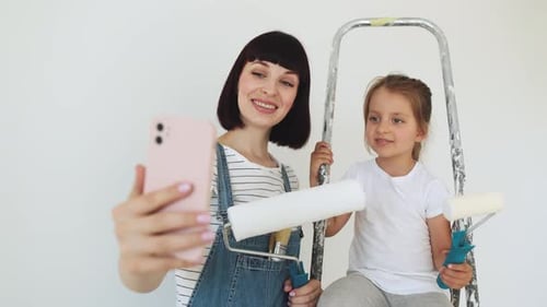 Woman and Child Posing with Painting Equipment