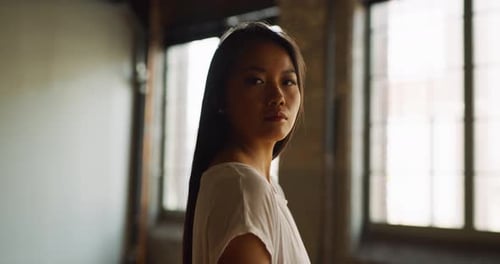 Beautiful Asian Dancer Glidesin Industrial Wood and Brick Windowed Loft During Daytime