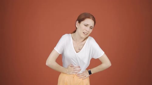 Woman experiencing stomachache.