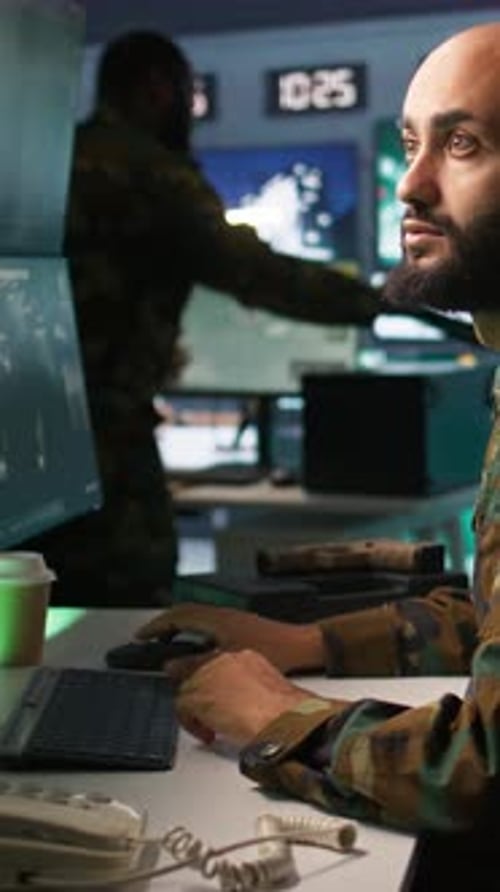 Vertical Video Army Specialist Overseeing National Safety Operations with Devices Close Up