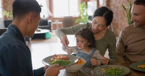 Extended Family with Toddler Eating Healthy Meal at Home