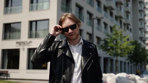 Stylish Man Poses in Urban Setting