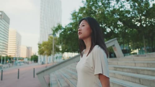Young Woman Walking in Modern City Area