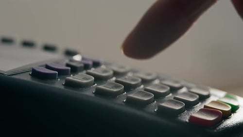 Finger Presses Buttons on Credit Card Terminal